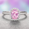 Iris Oval Pink Tourmaline Engagement Ring- 14K White Gold by Aquamarise Gold, featuring a vibrant pink tourmaline center surrounded by a halo of sparkling moissanite accents on a delicate white gold band.