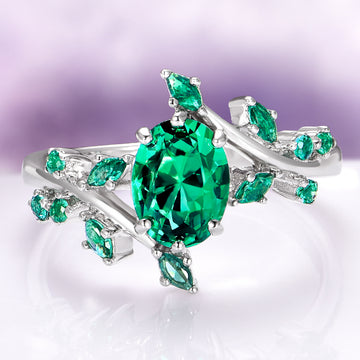 Oval Cut Lab-Grown Emerald Leaf Engagement Ring in 14K White Gold by Aquamarise Gold, featuring a vivid oval emerald and leaf-inspired accents from the Nature-Inspired Engagement Rings collection.