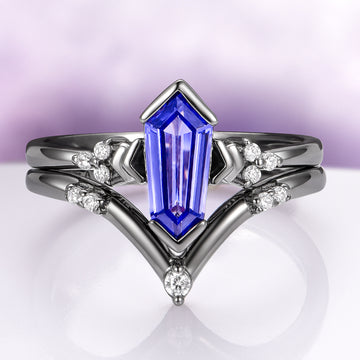 Orion Nebula™ & Tanzanite Couples Ring Set by Aquamarise, featuring a unique elongated tanzanite stone with diamond accents in a celestial-inspired black finish design.