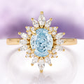 Aurora Natural Aquamarine Engagement Ring in 14K Solid Yellow Gold by Aquamarise Gold featuring an oval aquamarine center surrounded by marquise and round diamond accents in a vintage style.