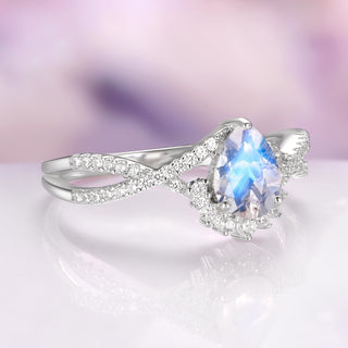 Alice Vintage Inspired Moonstone Engagement Ring in 14K White Gold by Aquamarise Gold featuring a pear-shaped moonstone with a sparkling twisted diamond-accented band design.