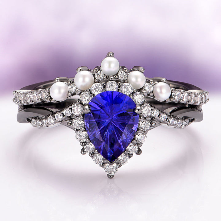 Ring with blue heart-shaped gemstone and pearls on a gradient background
