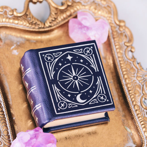 Night Court Handmade Leather Book Ring Box (Small) by Aquamarise with celestial design, placed on ornate gold tray with pink crystal accents, from Ring Boxes & Keepsake Proposals collection.