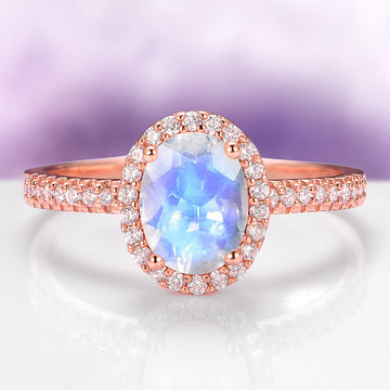 Galaxy Rainbow Moonstone Couples Ring Set featuring a luminous blue moonstone center with a sparkling diamond halo and pavé diamonds on a radiant rose gold band by Aquamarise.