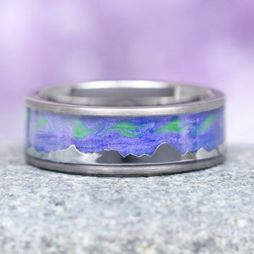 Borealis Tanzanite & Teal Sapphire Couples Ring Set (Mountain Range) by Aquamarise, featuring a polished band with a vibrant purple and green Northern Lights-inspired inlay above a sleek mountain silhouette, part of Matching Couples' Rings and Fantasy-Inspired Couples Rings collections.