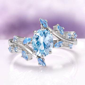 Aquamarine Fairy Leaf Engagement Ring in 14K White Gold by Aquamarise Gold, featuring an oval ice-blue aquamarine center stone surrounded by delicate leaf-shaped accents set in polished 14K white gold, part of collections including Solid Gold Engagement Rings, March Birthstone Jewelry, and Nature-Inspired Engagement Rings.