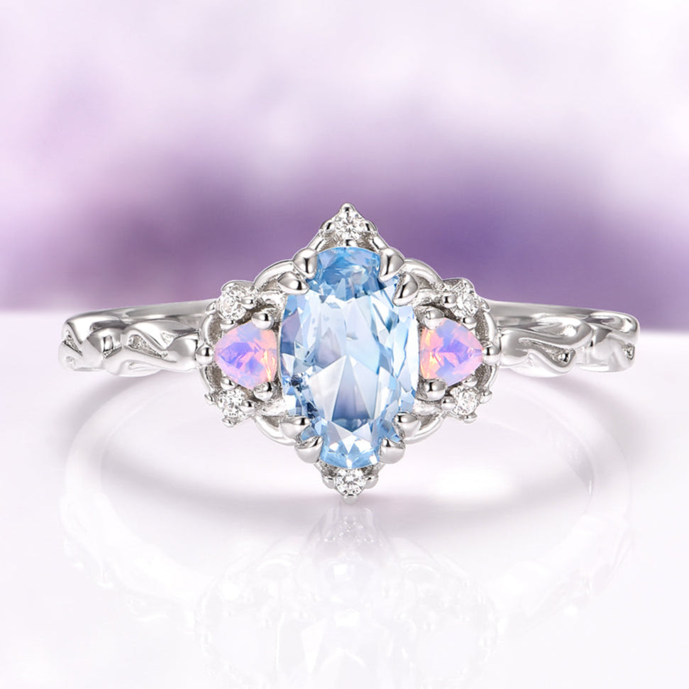 Silver ring with a blue gemstone on a light purple background