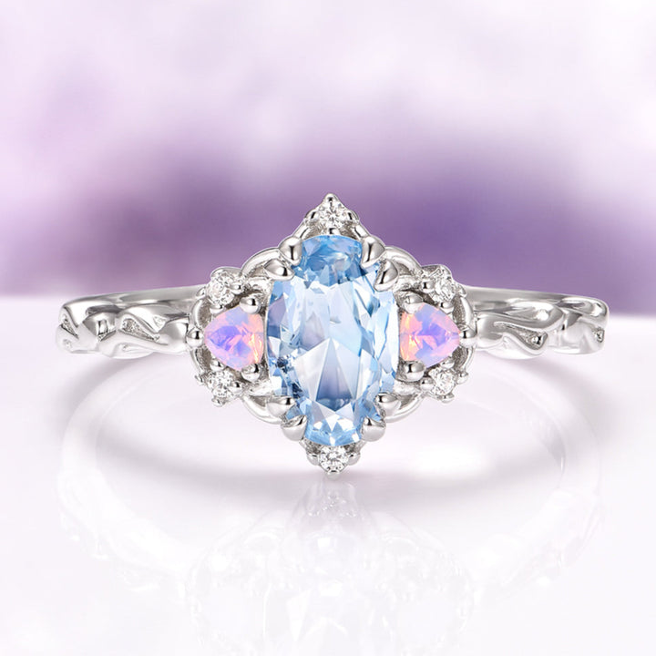 Silver ring with a blue gemstone on a light purple background