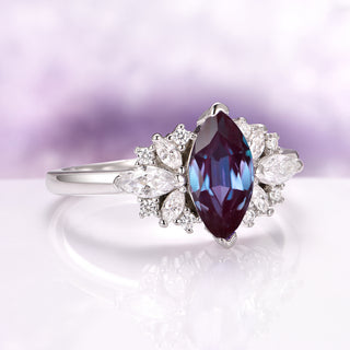 Adeline Marquise Cut Alexandrite Ring in Sterling Silver by Aquamarise featuring a deep color-changing marquise alexandrite center with sparkling white gemstone accents on a rhodium-finished band.