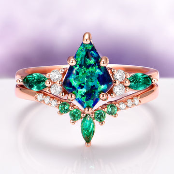 Skye Kite® Peacock Fire Opal & Emerald Engagement Ring Set in 14K Solid Rose Gold by Aquamarise Gold featuring a vibrant kite-shaped opal and sparkling emeralds in a unique rose gold setting.