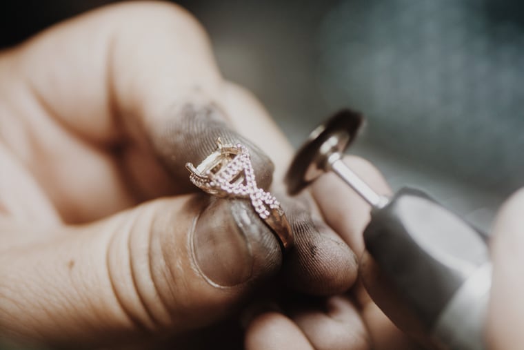 Jeweler polishing an Aquamarise ring at the studio bench