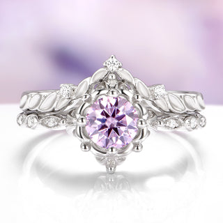 Silver ring with a pink gemstone on a white background