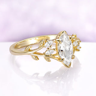 Nature-inspired marquise leaf engagement ring in solid 14K yellow gold by Aquamarise Gold with branch-style band