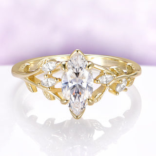 Marquise-cut leaf and branch engagement ring in solid 14K yellow gold by Aquamarise Gold with nature-inspired vine band