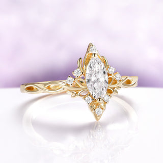 Butterfly-inspired marquise engagement ring in solid 14K yellow gold by Aquamarise Gold with accent stones