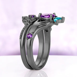 Side profile of the two-piece Claddagh ring set in black ruthenium, the two bands sitting flush with a round amethyst on the shoulder