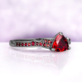 Angled view of the trillion garnet center ring alone in black ruthenium