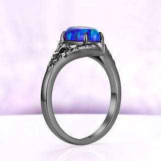 Side profile of the Nerida lavender opal ring in black ruthenium, the domed opal held in four prongs above the carved gallery
