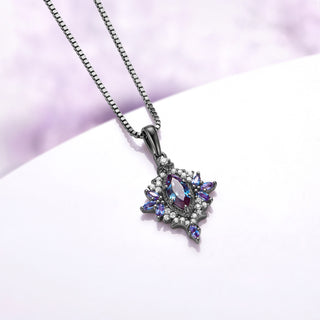 Angled view of the Nightbriar alexandrite pendant showing the color-shifting marquise rays, cubic zirconia halo and tapered bail on the box chain