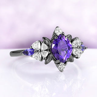 Angled view of the black leaf frame, heart cut blossom shoulders and marquise purple sapphire sides