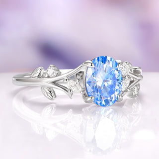 Silver ring with a blue gemstone on a white background