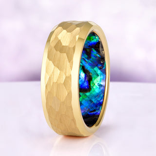 Gold ring with a colorful interior on a light purple background