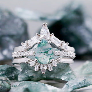 Pear Green Moss Agate Three-Piece Bridal Ring Set in Sterling Silver by Aquamarise, styled on rough green moss agate stones.