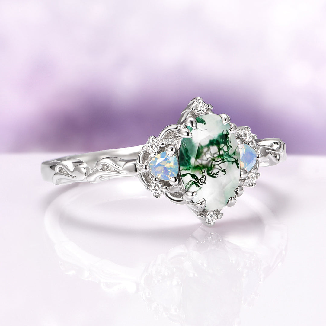 Silver ring with a green gemstone on a light purple background