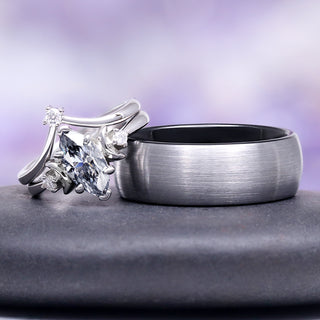 Two rings, one with a diamond and the other plain, on a gray surface with a purple gradient background.