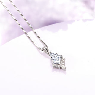 Diamond pendant necklace on a light purple background
