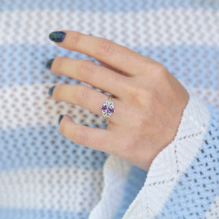 Adeline Marquise Cut Alexandrite Ring in Sterling Silver worn on hand with blue nail polish, styled with a textured white and blue knit sweater by Aquamarise.