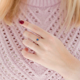 Vintage Alexandrite Fairytale Engagement Ring in 14K Rose Gold Vermeil by Aquamarise, featuring a petite color-shifting alexandrite with delicate rose gold and diamond accents on a hand with red nail polish.