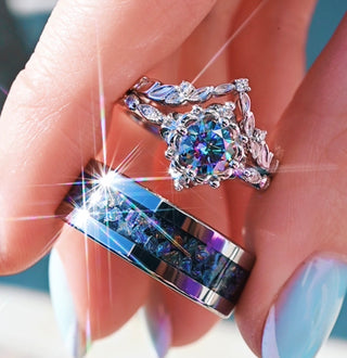 Close-up of a hand wearing two decorative rings with gemstones.