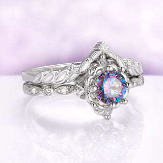 Silver ring with a colorful gemstone on a white background
