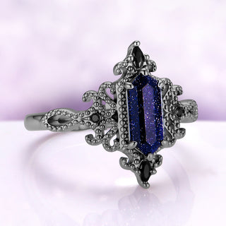 Angled view of the Ravenna Starry Night ring, showing the beaded scrolls, the marquise black onyx at each end and the looped shoulders
