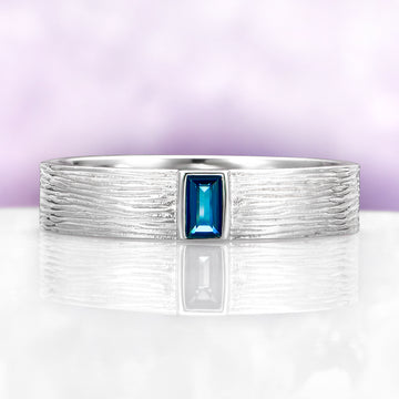 Celtic Natural London Blue Topaz Couples Ring Set by Aquamarise, featuring a textured sterling silver band with a rectangular London Blue Topaz center stone in a nature-inspired design.