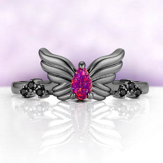 Selene Lab-Created Magenta Opal & Black Onyx Wing Ring in Black Ruthenium by Aquamarise, pear opal held between two sculpted wings with black onyx clusters on the shoulders