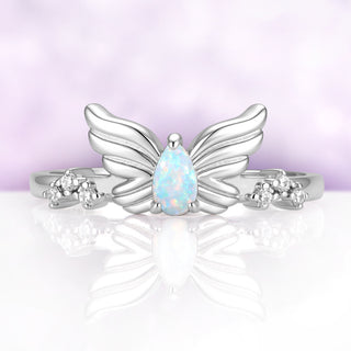 Selene Lab-Created White Fire Opal & Moissanite Wing Ring in Sterling Silver by Aquamarise, pear white opal held between two sculpted wings with moissanite clusters on the shoulders