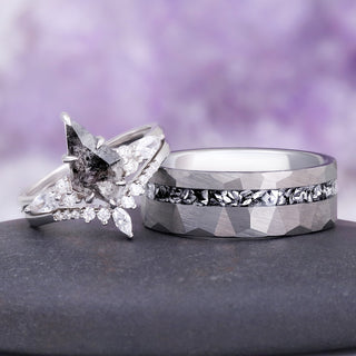 Skye Kite salt and pepper Herkimer diamond ring leaning against the hammered silver tungsten meteorite band on a dark stone, couples ring set by Aquamarise