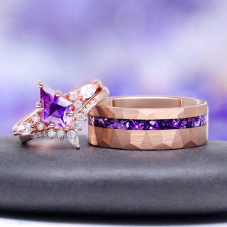 Two rings with purple gemstones on a dark surface with a blurred purple background