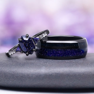 Pair of rings with blue gemstones on a gray surface with a blurred purple background