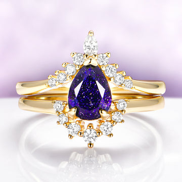 Starry Night Engagement Ring Set in 14K Solid Yellow Gold by Aquamarise Gold, featuring a pear-shaped deep blue gemstone with sparkling white diamond accents on polished yellow gold bands.