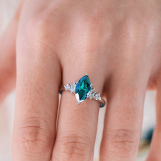 Ring with a blue gemstone on a finger against a neutral background