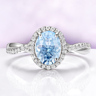 Diamond ring with a blue gemstone on a white background