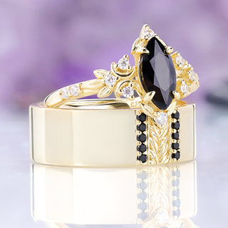 Angled view of the Viridian black onyx couples set in gold vermeil, her ring resting on his 8mm leaf band