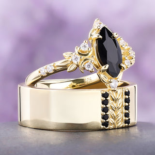 Viridian black onyx couples ring set in gold vermeil on a dark stone, her marquise ring stacked on his band