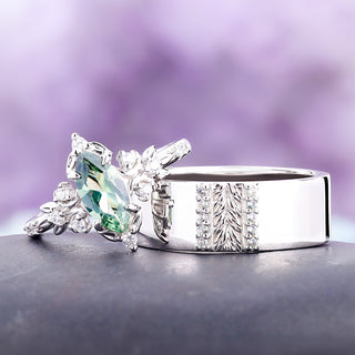 Viridian green tourmaline couples ring set in sterling silver: her marquise leaf and crescent moon ring beside his 8mm carved leaf band with channel-set tourmaline