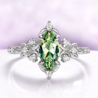 Marquise green tourmaline engagement ring in sterling silver with crescent moons and leaf shoulders