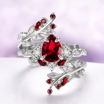 Wisteria Natural Red Garnet Leaf Couples Ring Set by Aquamarise, featuring sterling silver bands with detailed leaf designs and vibrant red garnet gemstones for matching couples rings.