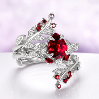 Wisteria Natural Red Garnet Leaf Couples Ring Set by Aquamarise, featuring sterling silver bands with natural red garnet gemstones and detailed leaf motifs for matching couples rings.